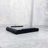 side profile of black roof rack mount on concrete background